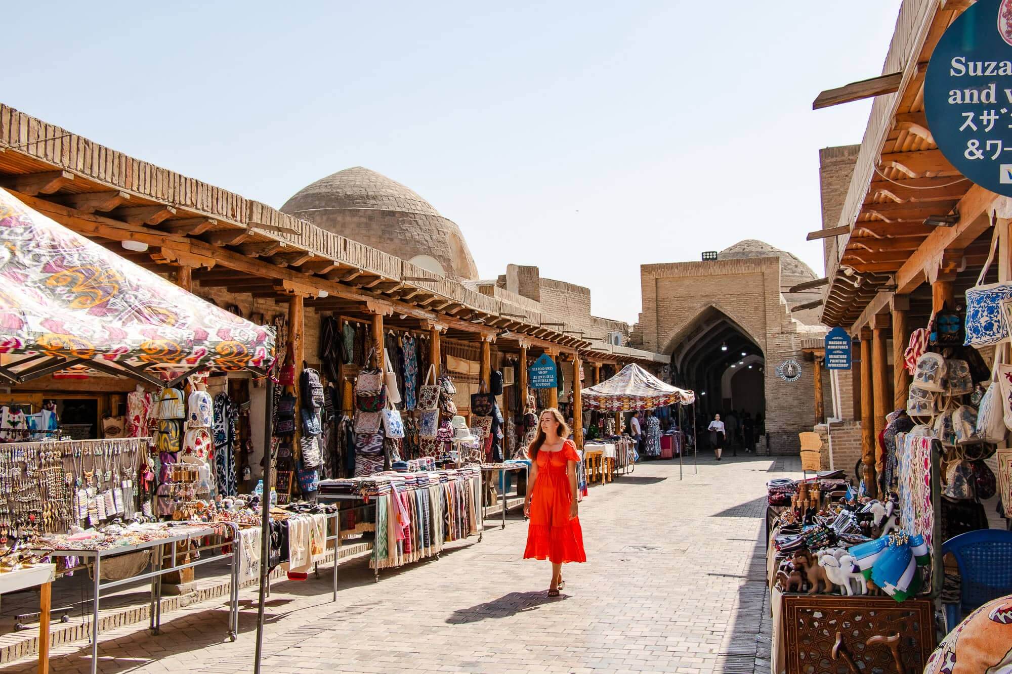 A local guide smiling and talking to travelers in a vibrant market